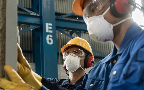 Workers wearing ear muffs.
