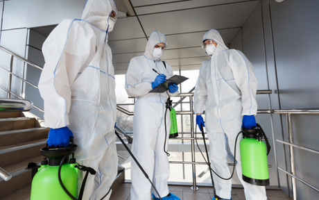 Workers geared up in hazmat suits