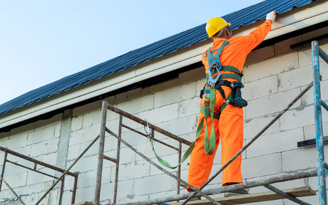 Worker has tools tethered while working at height.