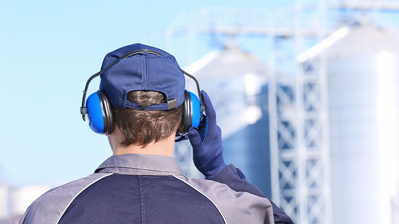 Worker wearing earmuffs as hearing protection.