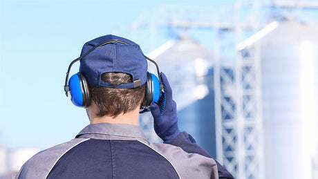Worker wearing earmuffs as hearing protection.