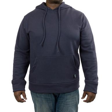 A person wearing the GRIT Pullover Hoodie Gray from GRIT FR Workwear stands against a white background. Complemented by blue jeans, this flame-resistant workwear offers both style and safety with its front pocket and drawstring hood.
