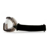 Featuring a side view of the Pyramex Low-Profile Chemical Splash Goggle from Pyramex Safety, this protective eyewear includes a black elastic strap for secure fastening. It has a clear lens with a slightly tinted, durable frame that showcases a modern sport design. Ideal for both safety and sports use, these goggles are compliant with ANSI Z87.1-2003 standards.